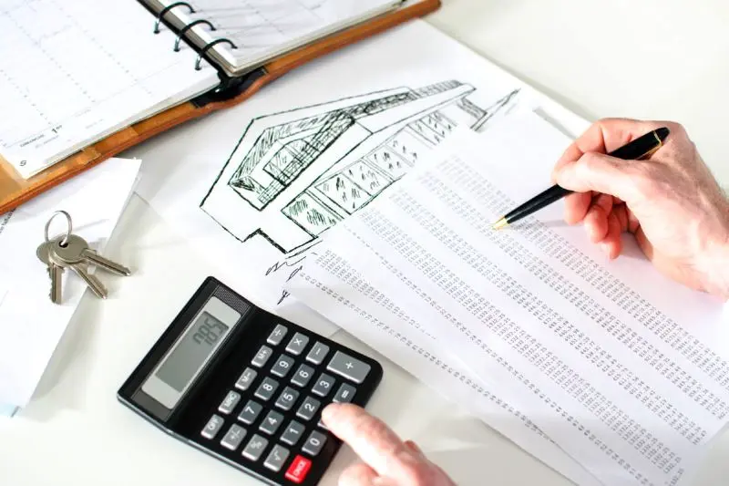 Hand-drawn home design and cost calculations used to outsource construction estimating in Alaska projects.
