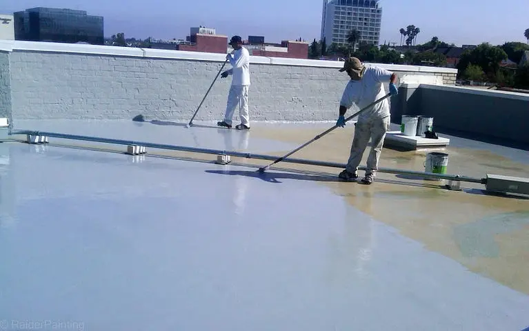 Rooftop coating application coordinated by top-tier Alaska Construction Estimation Services for durability.