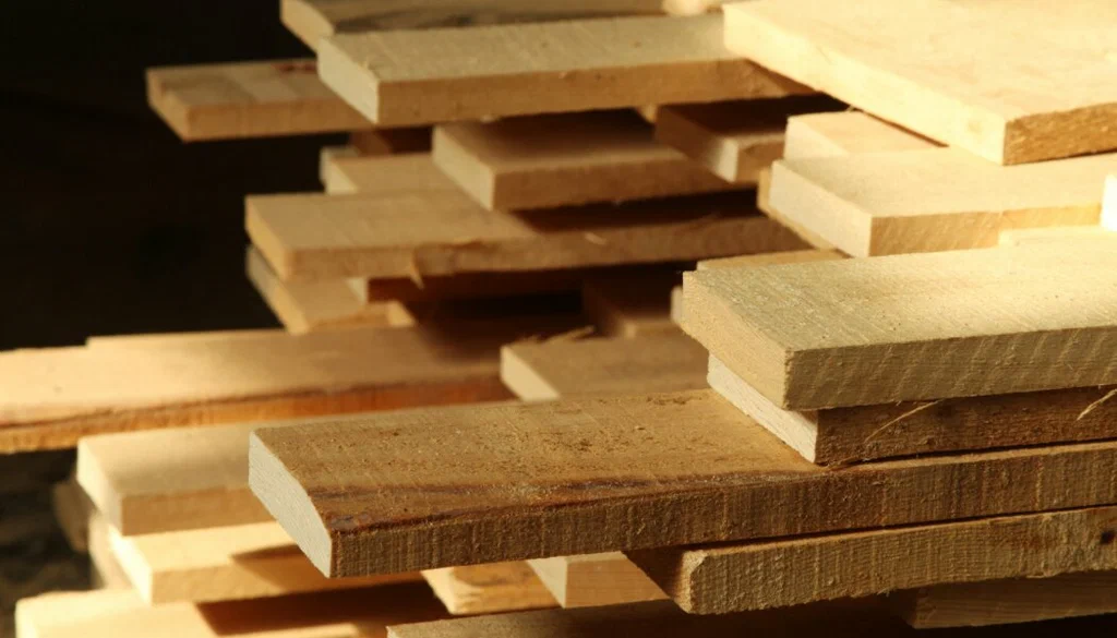 Stacked lumber materials being quantified through expert construction takeoff services Alaska.